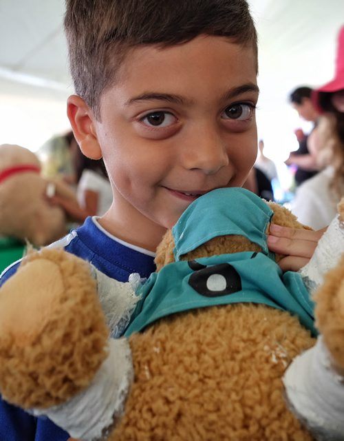 Frankie Rumore, 7, with his teddy bear at the Teddy Bears' Picnic at Assiniboine Park. The event brings around 30,000 people to the park, mostly kids with their stuffed toys that are damaged and need fixing. The money raised goes towards the Childrens Hospital Foundation of Manitoba.  150531 May 31, 2015 Mike Deal / Winnipeg Free Press