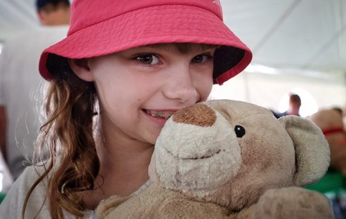 Reagan Jaworski, 8, with her teddy bear at the Teddy Bears' Picnic at Assiniboine Park. The event brings around 30,000 people to the park, mostly kids with their stuffed toys that are damaged and need fixing. The money raised goes towards the Childrens Hospital Foundation of Manitoba.  150531 May 31, 2015 Mike Deal / Winnipeg Free Press