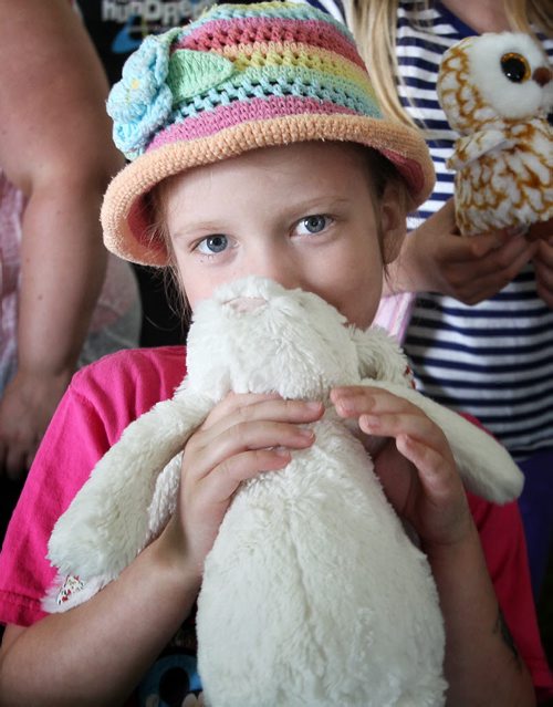 Hadley Umrau, 6, with her stuffy after it was treated by a doctor in the medical centre at the Teddy Bears' Picnic at Assiniboine Park. The event brings around 30,000 people to the park, mostly kids with their stuffed toys that are damaged and need fixing. The money raised goes towards the Childrens Hospital Foundation of Manitoba.  150531 May 31, 2015 Mike Deal / Winnipeg Free Press