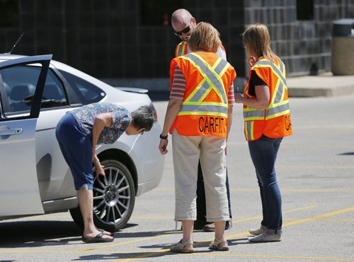 May 31, 2015 - 150531  -  CarFit technicians instruct a driver on safety while driving her car Sunday, May 31, 2015 at CAA Manitoba's St. Annes location. CAA Manitoba and the Canadian Association of Occupational Therapists (CAOT) have teamed up to host the first-ever CarFit event, aiming to keep maturing drivers behind the wheel, while keeping safety in mind. John Woods / Winnipeg Free Press