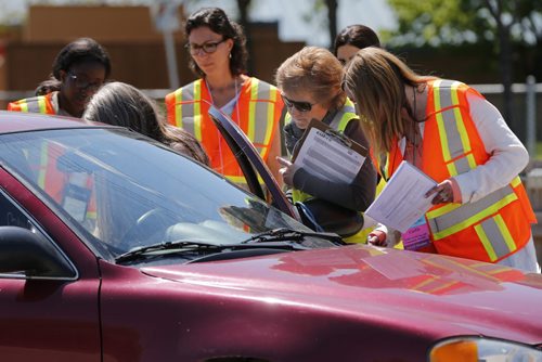 May 31, 2015 - 150531  -  Elin Schold Davis (C with clipboard), Project Coordinator America Occupational Therapy Association and CarFit technicians instruct a driver on safety while driving her car Sunday, May 31, 2015 at CAA Manitoba's St. Annes location. CAA Manitoba and the Canadian Association of Occupational Therapists (CAOT) have teamed up to host the first-ever CarFit event, aiming to keep maturing drivers behind the wheel, while keeping safety in mind. John Woods / Winnipeg Free Press