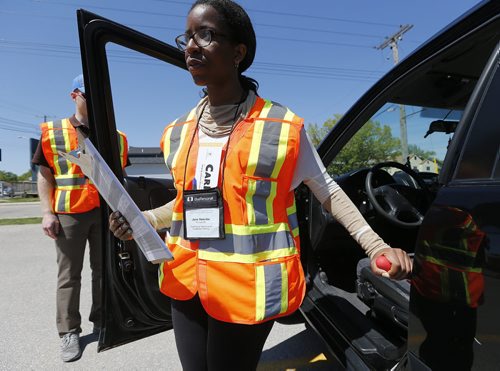 May 31, 2015 - 150531  -  Jane Nzeribe and Jeff Boniface, occupational therapists and CarFit technicians, instruct Julia Couture on safety while driving her car Sunday, May 31, 2015 at CAA Manitoba's St. Annes location. CAA Manitoba and the Canadian Association of Occupational Therapists (CAOT) have teamed up to host the first-ever CarFit event, aiming to keep maturing drivers behind the wheel, while keeping safety in mind. John Woods / Winnipeg Free Press