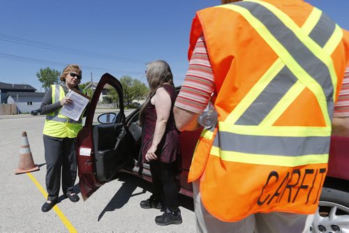 May 31, 2015 - 150531  -  Elin Schold Davis (C with clipboard), Project Coordinator America Occupational Therapy Association and a CarFit technician instruct Rosella Dyck on safety while driving her car Sunday, May 31, 2015 at CAA Manitoba's St. Annes location. CAA Manitoba and the Canadian Association of Occupational Therapists (CAOT) have teamed up to host the first-ever CarFit event, aiming to keep maturing drivers behind the wheel, while keeping safety in mind. John Woods / Winnipeg Free Press