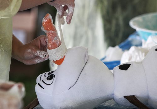 Olaf (from Disney's Frozen) has his nose tended to in the medical centre at the Teddy Bears' Picnic at Assiniboine Park. The event brings around 30,000 people to the park, mostly kids with their stuffed toys that are damaged and need fixing. The money raised goes towards the Childrens Hospital Foundation of Manitoba.  150531 May 31, 2015 Mike Deal / Winnipeg Free Press