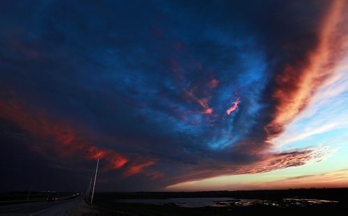 AT THE EDGE OF THE FRONT - A small storm cell swirls across the southern horizon west of Winnipeg Monday avening.....Forecast for tomorrow is......June 1, 2015 - (Phil Hossack / Winnipeg Free Press)