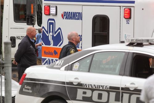 An ambulance gets ready to leave the scene of a stabbing outside Kelvin High School early Tuesday afternoon. 150602 June 2, 2015 Mike Deal / Winnipeg Free Press