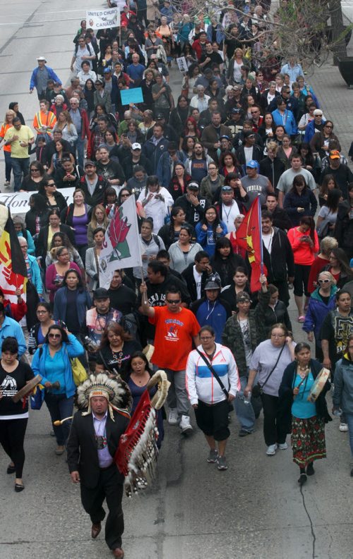 Assembly of Manitoba Chiefs Grand Chief Derek Nepinak leads a large group walks down Portage Ave in downtown Winnipeg to mark the release of The Truth and Reconciliation Commission report in Ottawa -See Mary Agnes Welch story- June 02, 2015   (JOE BRYKSA / WINNIPEG FREE PRESS)