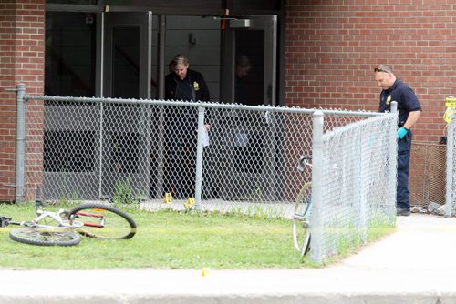 Kelvin Highschool stabbing scene. Police ident unit members work at the Stafford side door. BORIS MINKEVICH/WINNIPEG FREE PRESS June 2, 2015