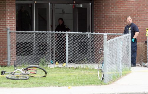 Kelvin Highschool stabbing scene. Police ident unit members work at the Stafford side door. BORIS MINKEVICH/WINNIPEG FREE PRESS June 2, 2015