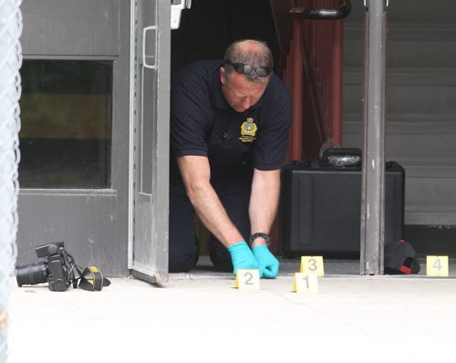 Kelvin Highschool stabbing scene. Police ident unit members work at the Stafford side door. BORIS MINKEVICH/WINNIPEG FREE PRESS June 2, 2015