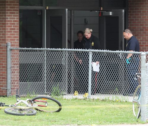 Kelvin Highschool stabbing scene. Police ident unit members work at the Stafford side door. BORIS MINKEVICH/WINNIPEG FREE PRESS June 2, 2015