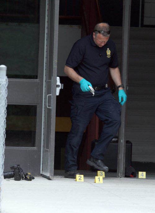 Kelvin Highschool stabbing scene. Police ident unit members work at the Stafford side door. BORIS MINKEVICH/WINNIPEG FREE PRESS June 2, 2015