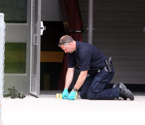 Kelvin Highschool stabbing scene. Police ident unit members work at the Stafford side door. BORIS MINKEVICH/WINNIPEG FREE PRESS June 2, 2015