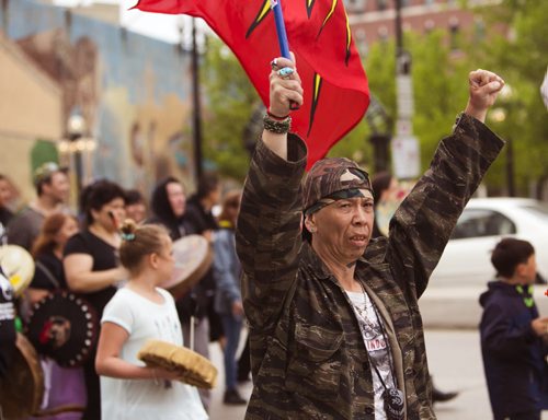 Vin Clarke puts both hands in the air on the Walk for Reconciliation on Tuesday, June 2, 2015.  The march went through downtown from the University of Winnipeg, and finished at the Thunderbird House for a feast and pipe ceremony. Mikaela MacKenzie / Winnipeg Free Press