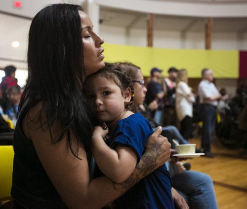 Charlotte Boubard holds her daughter, Toni, while singing at the Thunderbird House after the Walk for Reconciliation on Tuesday, June 2, 2015.  The march went through downtown from the University of Winnipeg, and finished at the Thunderbird House for a feast and pipe ceremony. Mikaela MacKenzie / Winnipeg Free Press