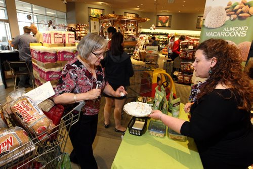 BIZ - Pina Romolo (in photo handing out samples) and her mother have an Italian cookie company called Piccola Cucina which was recently featured as one of the ten new Canadian companies on the rise. The cookies have recently been added to Co-Op shelves and she is a doing a demo at the store today. No ID on customers. BORIS MINKEVICH/WINNIPEG FREE PRESS June 2, 2015