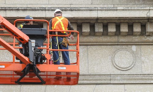 Michael Scott (white hardhat), a heritage architect with Charles Hazell Associates and Larry Gibson (blue hardhat) with Total Co-ordination construction examine the tyndall stone structure of the legislative building gathering data for upcoming repairs. 150602 - Tuesday, June 02, 2015 -  MIKE DEAL / WINNIPEG FREE PRESS