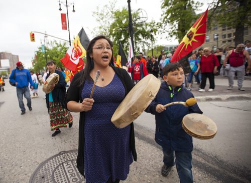 Dawn Lavand (left), descendant of a residential school survivor, drums with her son, Zachary Coffin, on the Walk for Reconciliation on Tuesday, June 2, 2015.  The march went through downtown from the University of Winnipeg, and finished at the Thunderbird House for a feast and pipe ceremony. Mikaela MacKenzie / Winnipeg Free Press