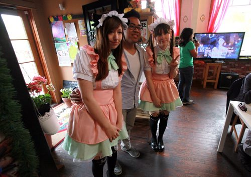 A patrom poses for a snapshot with the "Maids" at Dwarf & Cachette, a Japanese restaurant that incorporates cos-play, anime etc. into its menu.  See Dave Sanderson's story. On Tuesday, the restaurant is hosting a special event - the first of its kind - when waitresses will dress in Japanese  maid's garb, to personally serve customers (i still don't know what this all means - I'm going there at noon to get the gist of it all...) Apparently this is a big thing in Japan and Dwarf & Cachette is the first Japanese restaurant in Winnipeg to incorporate  this type of service... June 2, 2015  - (Phil Hossack / Winnipeg Free Press)