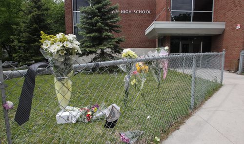 A memorial of flowers set up outside the doors to Kelvin High School Wednesday the day close to where former student Brett Bourne was stabbed. Bourne died in hospital from his injuries. 150603 - Wednesday, June 03, 2015 -  MIKE DEAL / WINNIPEG FREE PRESS