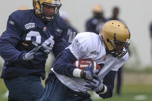 Darvin Adams (4) is chased by Deantre Harlan (94) during day 4 of the Winnipeg Blue Bomber training camp Wednesday morning. 150603 - Wednesday, June 03, 2015 -  MIKE DEAL / WINNIPEG FREE PRESS