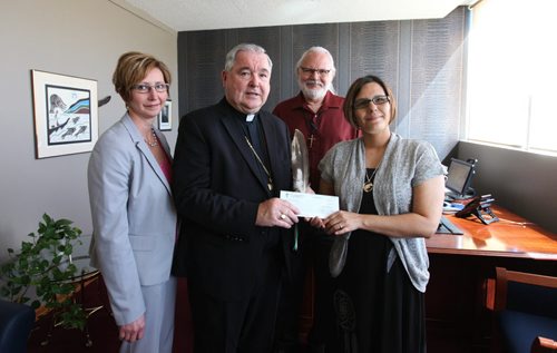 Archbishop Richard Gagnon along with Rhonda Chorney, CFO of Archdiocese of Wpg (left), present donation cheque of $60,000 to Lisa Raven, Executive Director of Returning to Spirit, and Rev. Francois Paradis, a priest at St. Kateri Tekakwitha Aboriginal Parish at the Catholic Centre Thursday morning in Wpg.   The money was collected from its Centennial Mass, attended by 13,000 faithful at MTS Centre May 3 and will go toward this Aboriginal non-profit charitable organization providing reconciliation and healing workshops that  bring Aboriginals and Non-Aboriginals together. See Alex Paul story.   June 04, 2015 Ruth Bonneville / Winnipeg Free Press