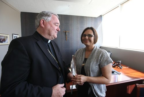 Archbishop Richard Gagnon presents donation cheque of $60,000 to Lisa Raven, Executive Director of Returning to Spirit  at the Catholic Centre Thursday morning in Wpg.  The money was collected from its Centennial Mass, attended by 13,000 faithful at MTS Centre May 3 and will go toward this Aboriginal non-profit charitable organization providing reconciliation and healing workshops that  bring Aboriginals and Non-Aboriginals together. See Alex Paul story.   June 04, 2015 Ruth Bonneville / Winnipeg Free Press
