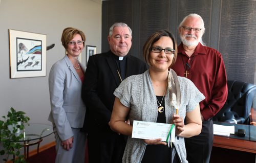 Archbishop Richard Gagnon along with Rhonda Chorney, CFO of Archdiocese of Wpg, present donation cheque of $60,000 to Lisa Raven, Executive Director of Returning to Spirit, and Rev. Francois Paradis, a priest at St. Kateri Tekakwitha Aboriginal Parish at the Catholic Centre Thursday morning in Wpg.   The money was collected from its Centennial Mass, attended by 13,000 faithful at MTS Centre May 3 and will go toward this Aboriginal non-profit charitable organization providing reconciliation and healing workshops that  bring Aboriginals and Non-Aboriginals together. See Alex Paul story.   June 04, 2015 Ruth Bonneville / Winnipeg Free Press