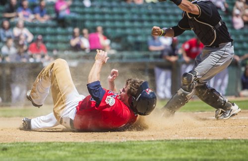 Aaron Baker of the Goldeyes slides into home a moment too late at Shaw Park on Thursday, June 4, 2015. Mikaela MacKenzie / Winnipeg Free Press