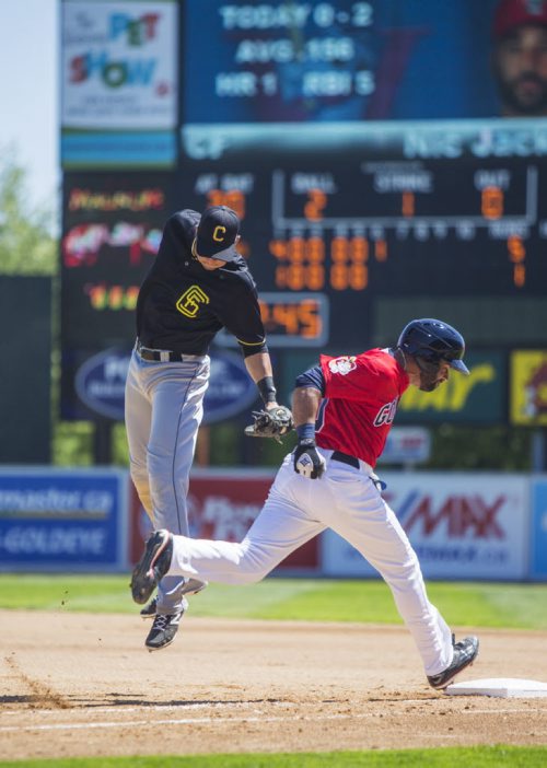 Outfielder Edwin Gomez of the Sioux Falls Canaries attempts to get Goldeye Nic Jackson out at Shaw Park on Thursday, June 4, 2015. The Sioux Falls Canaries won 7-4. Mikaela MacKenzie / Winnipeg Free Press