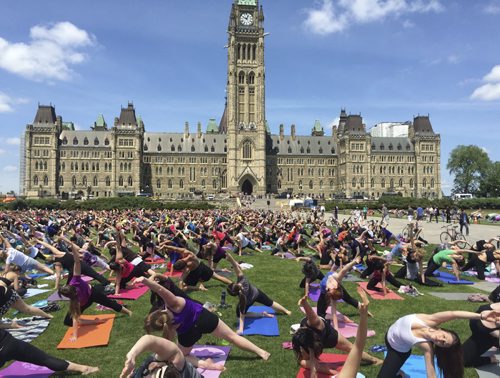 Nearly 2,000 people gathered Wednesday for weekly Yoga on the Hill, a weekly event that has not been affected by security improvements on Parliament Hill after last fall's shooting. June 3, 2015 Mia Rabson / Winnipeg Free Press