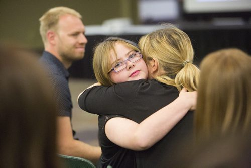 Kaitlin Rempel receives a hug after winning the Louise Staples Award for school patrolling at the RBC Convention Centre on Friday, June 5, 2015. Mikaela MacKenzie / Winnipeg Free Press