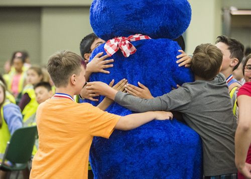 Patrollers hug Boston Pizza mascot Lionel in the RBC Convention Centre, where they were gathered to receive awards for outstanding work on Friday, June 5, 2015. Mikaela MacKenzie / Winnipeg Free Press