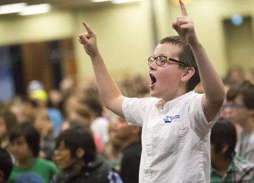 Alec Compton, grade five student at St. Charles Catholic School, stands up to cheer at the school patrol awards held at the RBC Convention Centre on Friday, June 5, 2015. Mikaela MacKenzie / Winnipeg Free Press