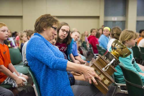 Renelle Bohemier, teacher at Ecole Laura Secord, examines their trophy at the school patrol awards held at the RBC Convention Centre on Friday, June 5, 2015.  Bohemier has been involved with patrolling for 21 years. Mikaela MacKenzie / Winnipeg Free Press