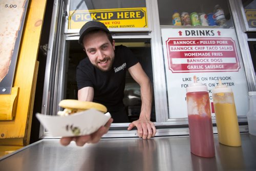 Anthony Faraci, owner of the Bannock Factory Food Trailer, hands a bannock sandwich to a customer on Friday, June 5, 2015. Mikaela MacKenzie / Winnipeg Free Press