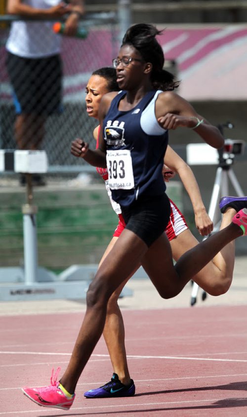 Agony of defeat, Kelvin High's Sciera Opaleke grimaces as Toayo Babalola steps a stride ahead as the pair cross the finish line in the Varsity Girls 200 meter dash Friday at the MSHAA Provincial Track and Field Championships at University Stadium at the University of Manitoba. June 5, 2015 - (Phil Hossack / Winnipeg Free Press)