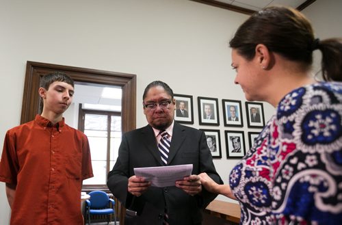 Maeengan Linklater presents documents for his proposed Manitoba Indian Residential School Genocide and Reconciliation Memorial Day Act to Deputy Progressive Conservative leader Heather Stefanson at the Manitoba Legislature Friday afternoon. Accompanied by his son Aandeg Mian Muldrew June 05, 2015 - MELISSA TAIT / WINNIPEG FREE PRESS
