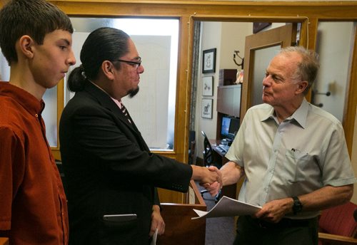 Maeengan Linklater presents documents for his proposed Manitoba Indian Residential School Genocide and Reconciliation Memorial Day Act to River Heights Liberal MLA Jon Gerrard at the Manitoba Legislature Friday afternoon. HIs son Aandeg Mian Muldrew joined Linklater. June 05, 2015 - MELISSA TAIT / WINNIPEG FREE PRESS