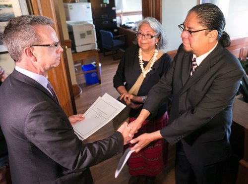 Maeengan Linklater presents documents for his proposed Manitoba Indian Residential School Genocide and Reconciliation Memorial Day Act to Education Minister James Allum at the Manitoba Legislature Friday afternoon. Accompanied by his mother, and Residential School Survivor, Patricia Ningewance-Nadeau. June 05, 2015 - MELISSA TAIT / WINNIPEG FREE PRESS