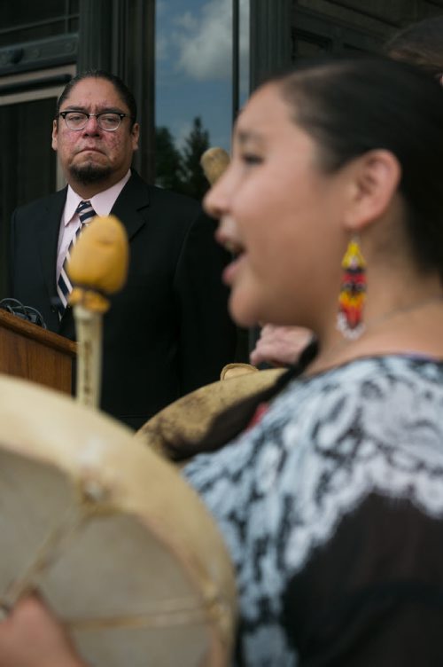 Maeengan Linklater watches a drum ceremony before delivering his proposed Manitoba Indian Residential School Genocide and Reconciliation Memorial Day Act to political party offices at the Manitoba Legislature Friday afternoon. June 05, 2015 - MELISSA TAIT / WINNIPEG FREE PRESS