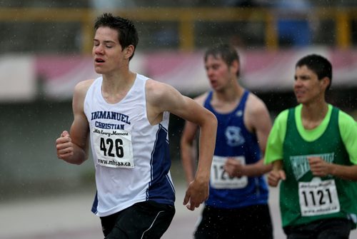 Nathan Dewitt on his way to winning a 3000m race at the MSHAA Provincial Track and Field Championships during heavy rain, at University Stadium at the University of Manitoba, Saturday, June 6, 2015. (TREVOR HAGAN/WINNIPEG FREE PRESS)