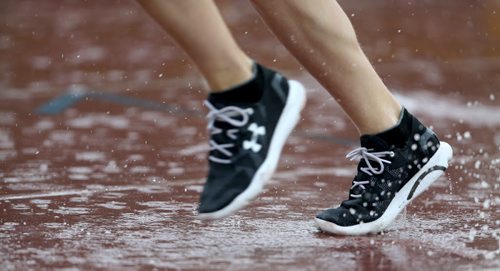 Rain hitting the track during a 3000m race during the MSHAA Provincial Track and Field Championships, at University Stadium at the University of Manitoba, Saturday, June 6, 2015. (TREVOR HAGAN/WINNIPEG FREE PRESS)