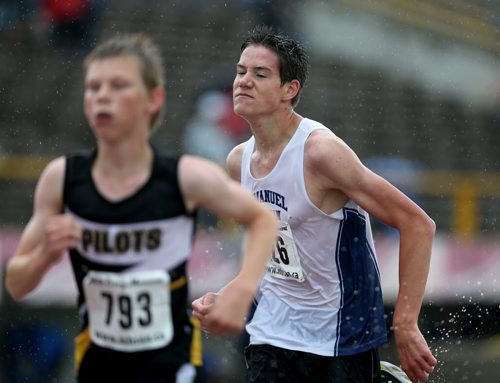 Nathan Dewitt on his way to winning a 3000m race at the MSHAA Provincial Track and Field Championships during heavy rain, at University Stadium at the University of Manitoba, Saturday, June 6, 2015. (TREVOR HAGAN/WINNIPEG FREE PRESS)