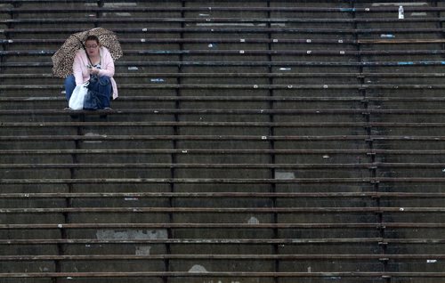 A spectator during MSHAA Provincial Track and Field Championships during heavy rain, at University Stadium at the University of Manitoba, Saturday, June 6, 2015. (TREVOR HAGAN/WINNIPEG FREE PRESS)