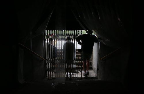 Spectators take shelter under the stands during MSHAA Provincial Track and Field Championships during heavy rain, at University Stadium at the University of Manitoba, Saturday, June 6, 2015. (TREVOR HAGAN/WINNIPEG FREE PRESS)