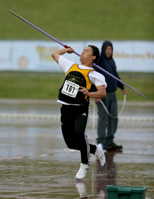 A javelin competitor throws during the MSHAA Provincial Track and Field Championships during heavy rain, at University Stadium at the University of Manitoba, Saturday, June 6, 2015. (TREVOR HAGAN/WINNIPEG FREE PRESS)