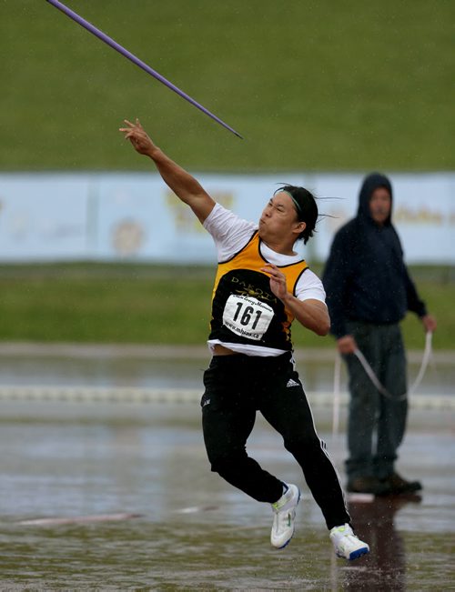 A javelin competitor throws during the MSHAA Provincial Track and Field Championships during heavy rain, at University Stadium at the University of Manitoba, Saturday, June 6, 2015. (TREVOR HAGAN/WINNIPEG FREE PRESS)