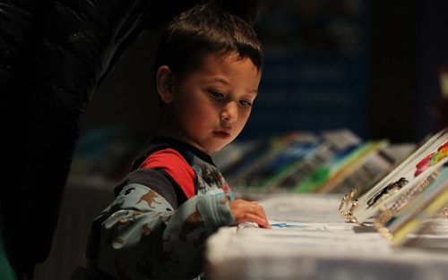 Four and a half year old Oliver Brans looks at artwork created by students in the Pembina Trails School Division  for a Unicef project on display in Buhler Hall at CMHR Saturday with his mom.   See Alex Paul story.    June 06, 2015 Ruth Bonneville / Winnipeg Free Press