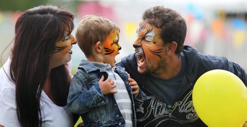 Two-and-a-half-year-old, Mason Martins lifts his chest up and roars like a wild cat with his dad after the family, Reena and George Martins finished getting their face painted at Kid Fest Saturday  at the Forks.  Standup photo    June 06, 2015 Ruth Bonneville / Winnipeg Free Press
